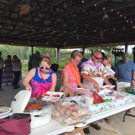 group of people enjoying a party in the pavilion at Sparrow Pond Family Campground